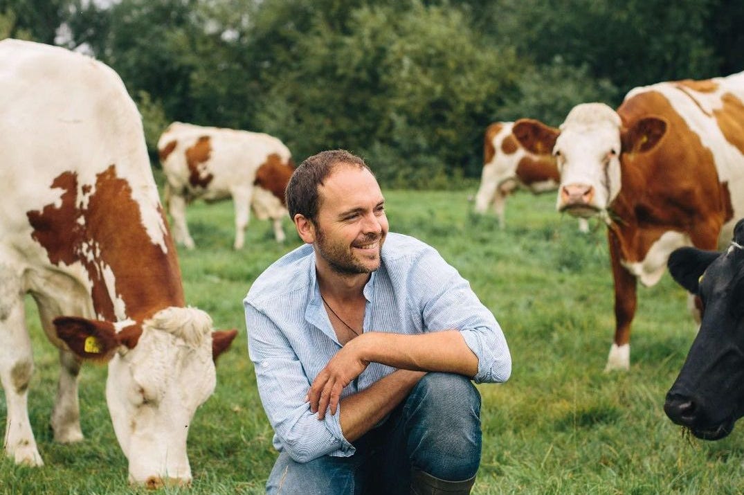 Jonny Crickmore of Fen Farm Dairy with his herd of cows