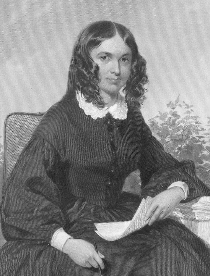 Black and white portrait of Elizabeth Barrett Browning seated in a black dress and white lace collar with papers in hand