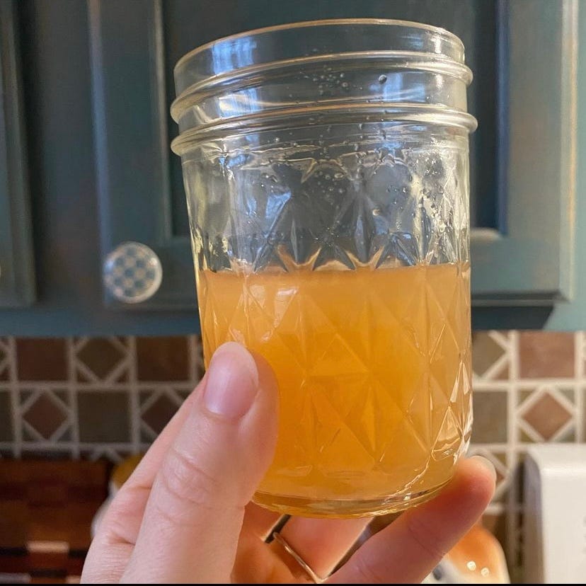 hand holding a half-full mason jar