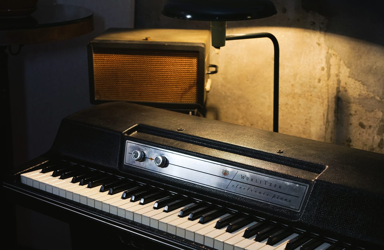 Wurlitzer 203w with the keys illuminated by a vintage flying saucer lamp.