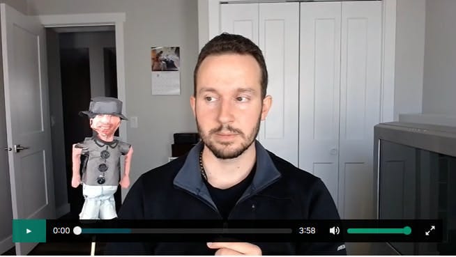 Scott Bartlett featured in a video staring at a paper mache replica of Joshua James