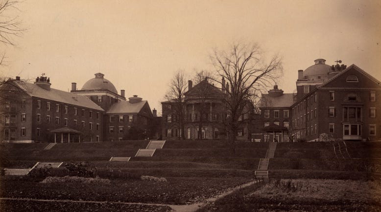 Sepia photo of rolling lawns and brick buildings resembling a college campus