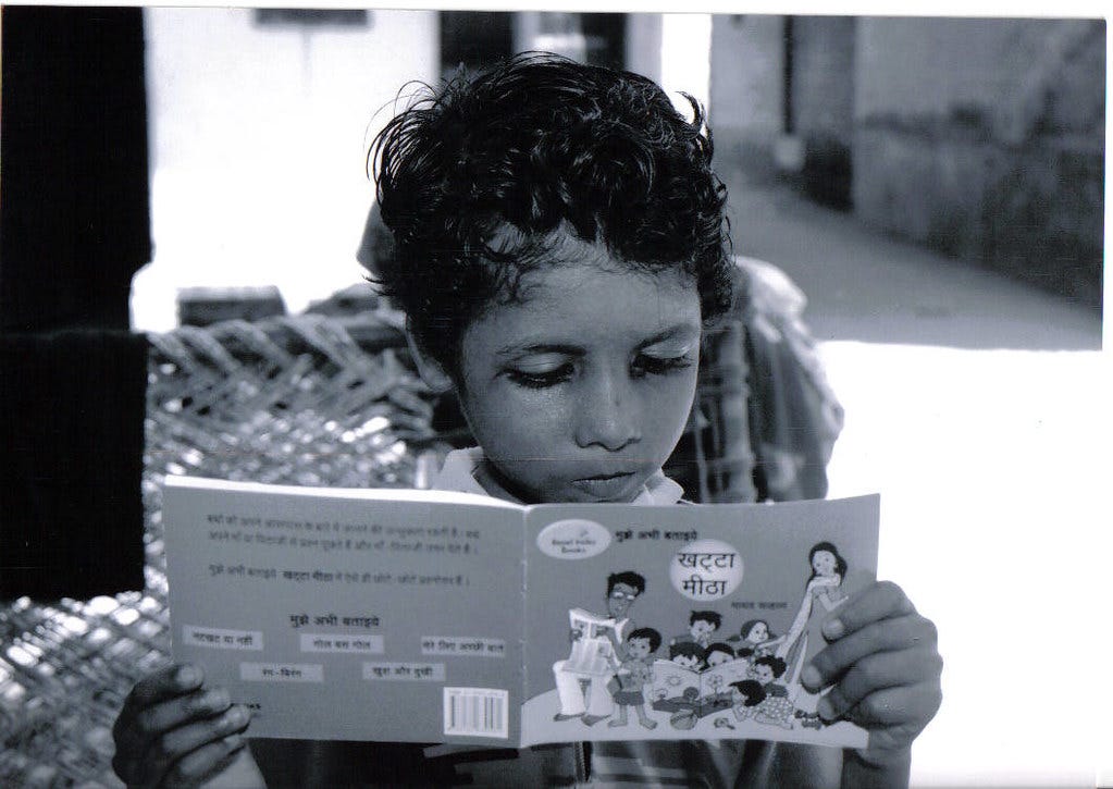 A child reading a book by Pratham Books