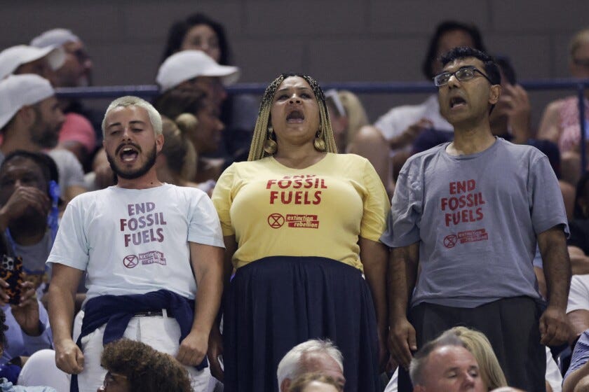 Environmental protestors wearing "End Fossil Fuel" t-shirts disturb and delay the match between USA's Coco Gauff and Czech Republic's Karolina Muchova during the US Open tennis tournament women's singles semi-finals match at the USTA Billie Jean King National Tennis Center in New York City, on September 7, 2023.