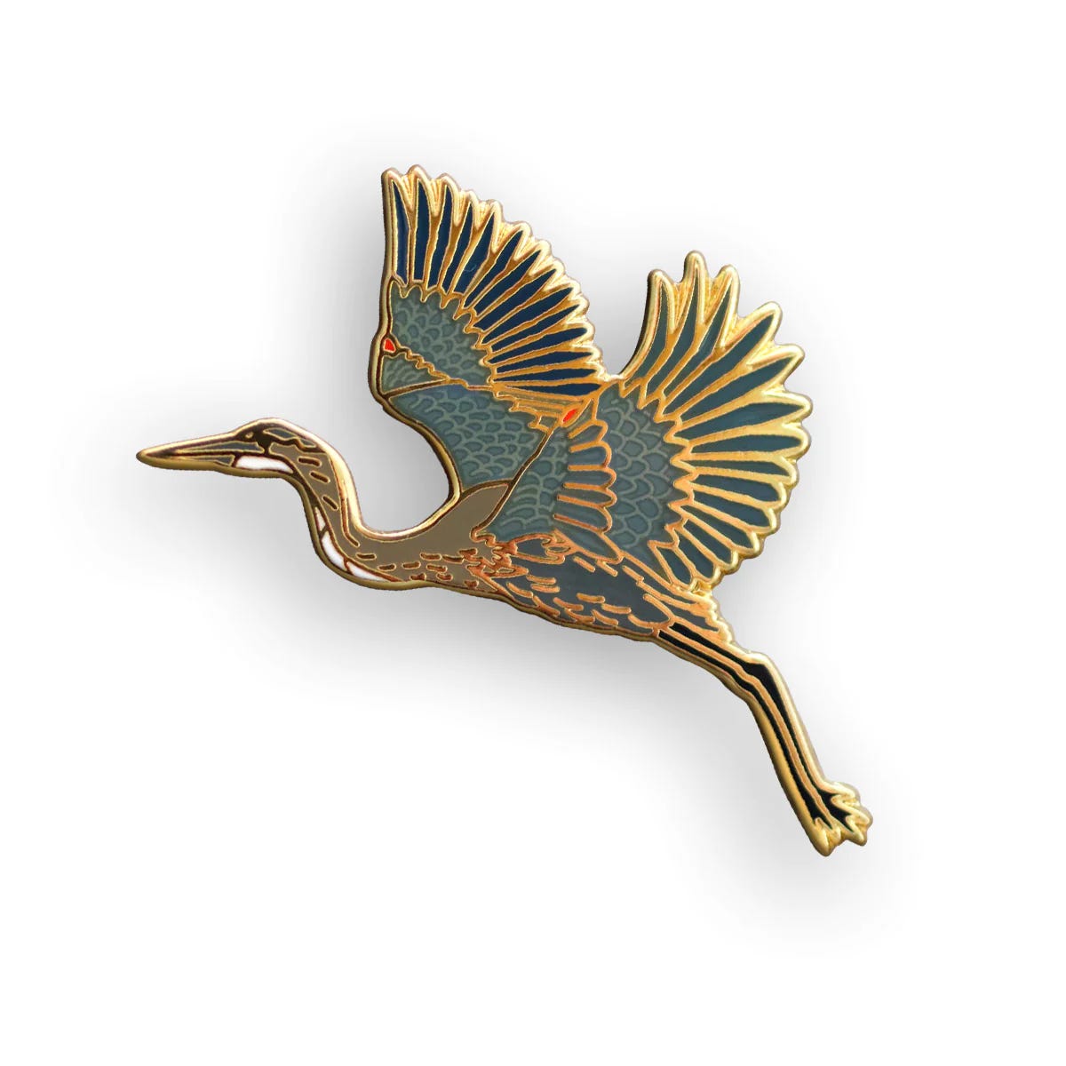 A gold metal pin badge in the shape of a blue heron bird with feathering detail in colour ink.