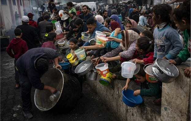 Palestinians queue for food in Rafah.