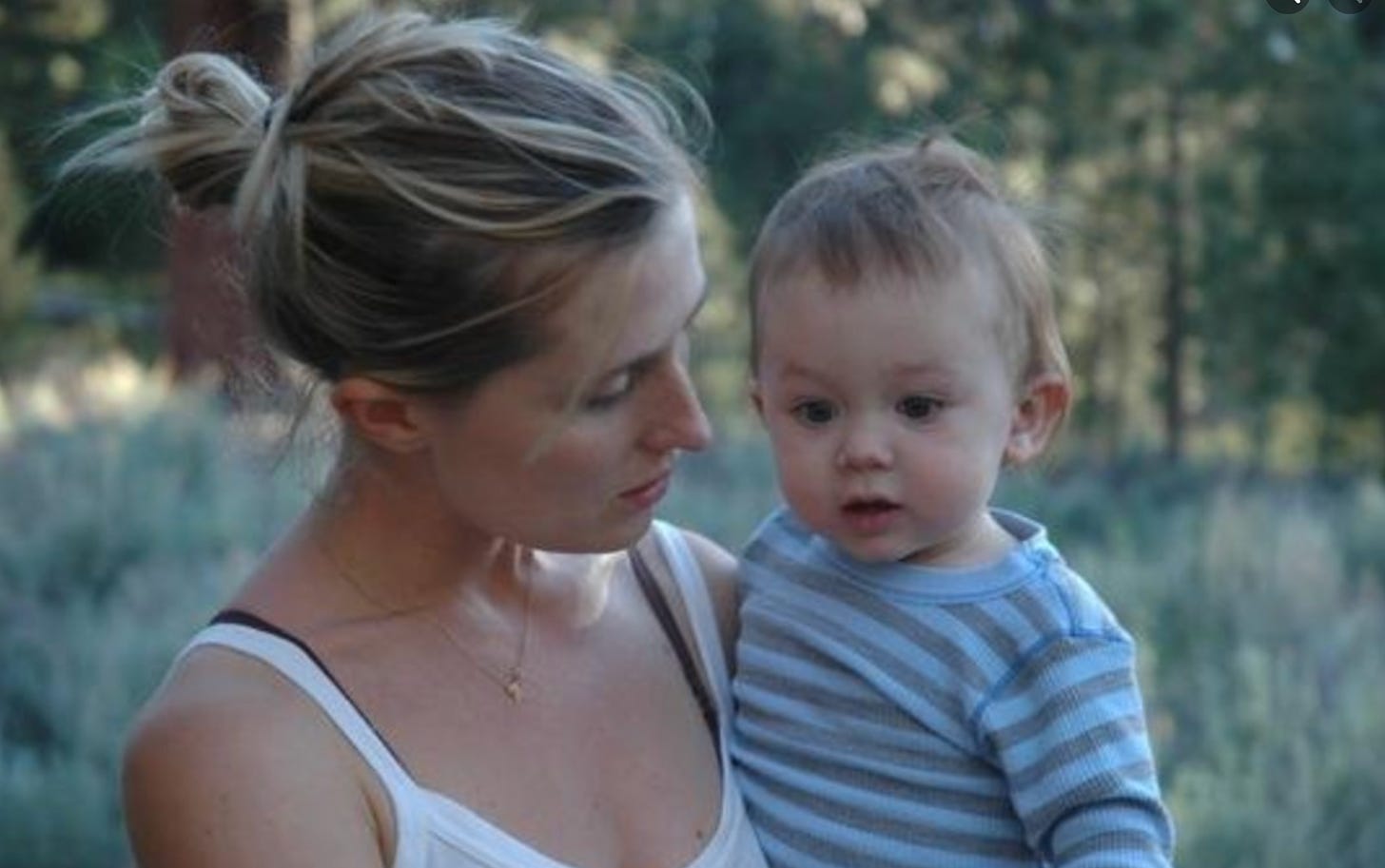 the author, a white woman with blonde hair in a bun, holding her little boy, also blonde, age 1