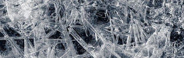 Natural background of ice crystals randomly covering a dark surface