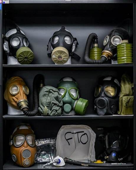 Shelves full of different kinds of gas masks.