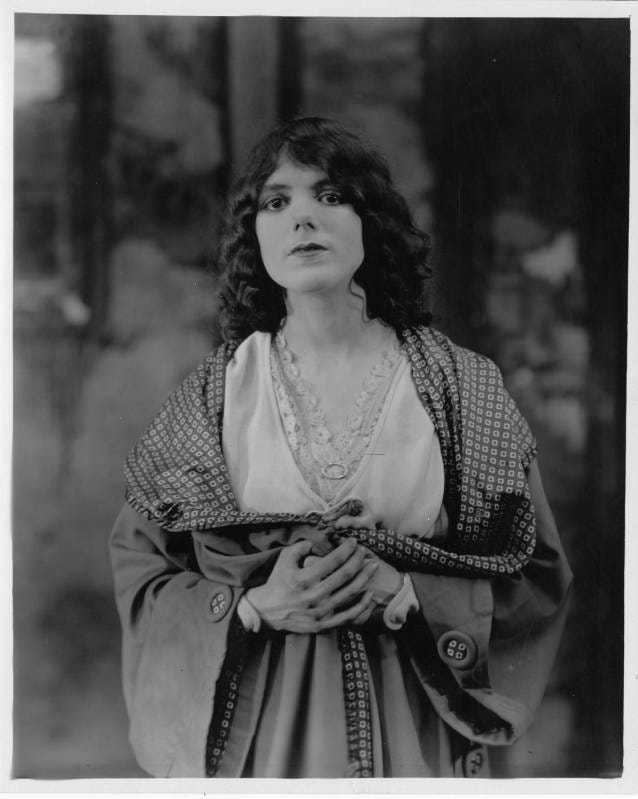 a black and white photo of a woman with dark hair