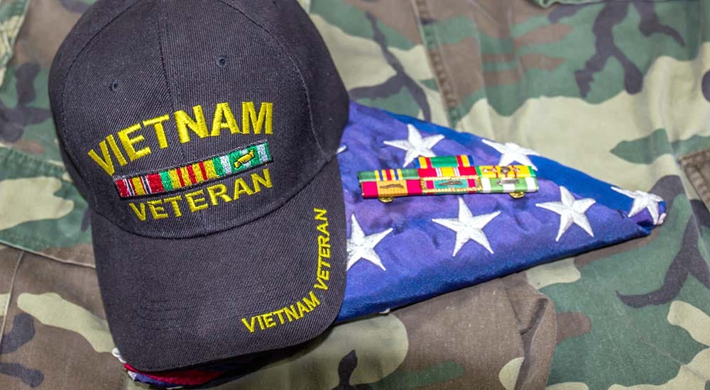 Vietnam Veteran cap, flag, medals, uniform