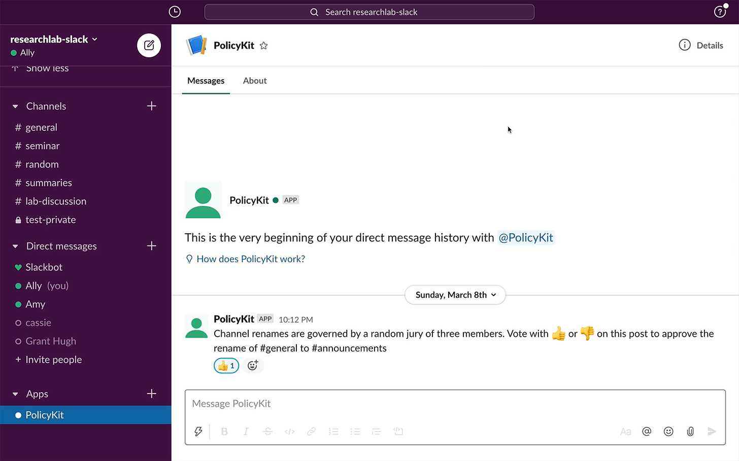A screenshot of the app Slack, with the signature purple menu bar at left and white field at right. A direct message with “PolicyKit APP” is shown, with the message: “Channel renames are governed by a random jury of three members. Vote with (thumbs up) or (thumbs down) on this post to approve the rename of #general to #announcements”