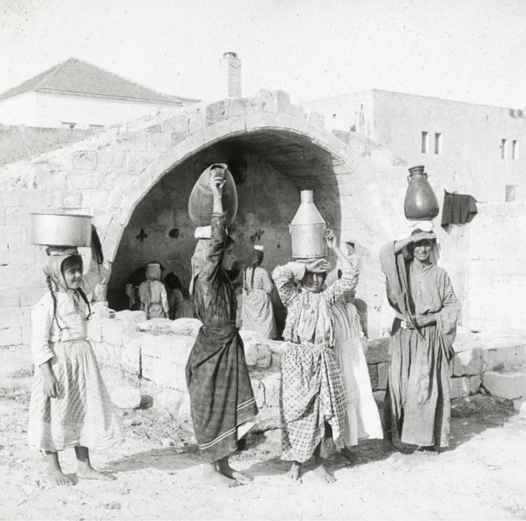 Historical photo of Palestinian Christian women gathered in front of Mary’s Well in Nazareth, 1914.