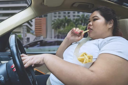 Asian obese woman eating during driving a car Stock Photo | Adobe Stock