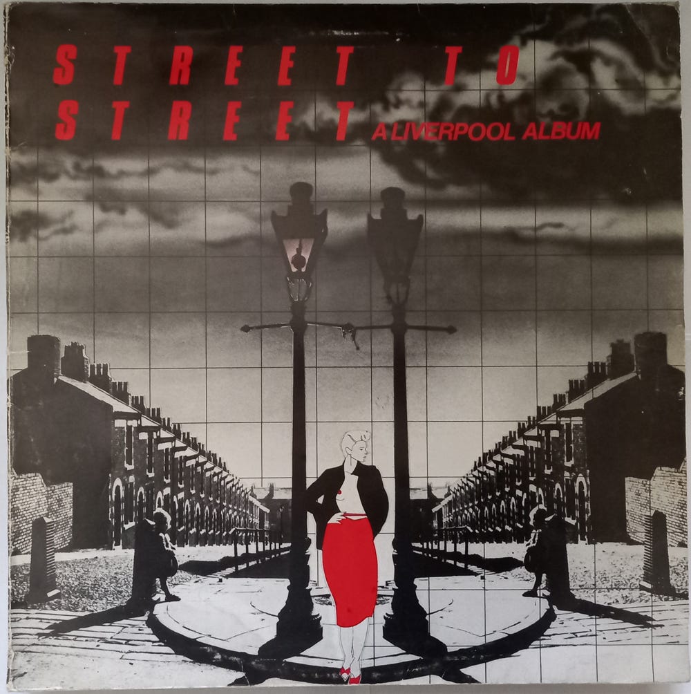 The front of the "Street to Street" LP sleeve. A drawing of a Liverpool street, with a young woman in a pencil skirt in the foreground. The picture is in black and white, while the album title and the woman's skirt are red.