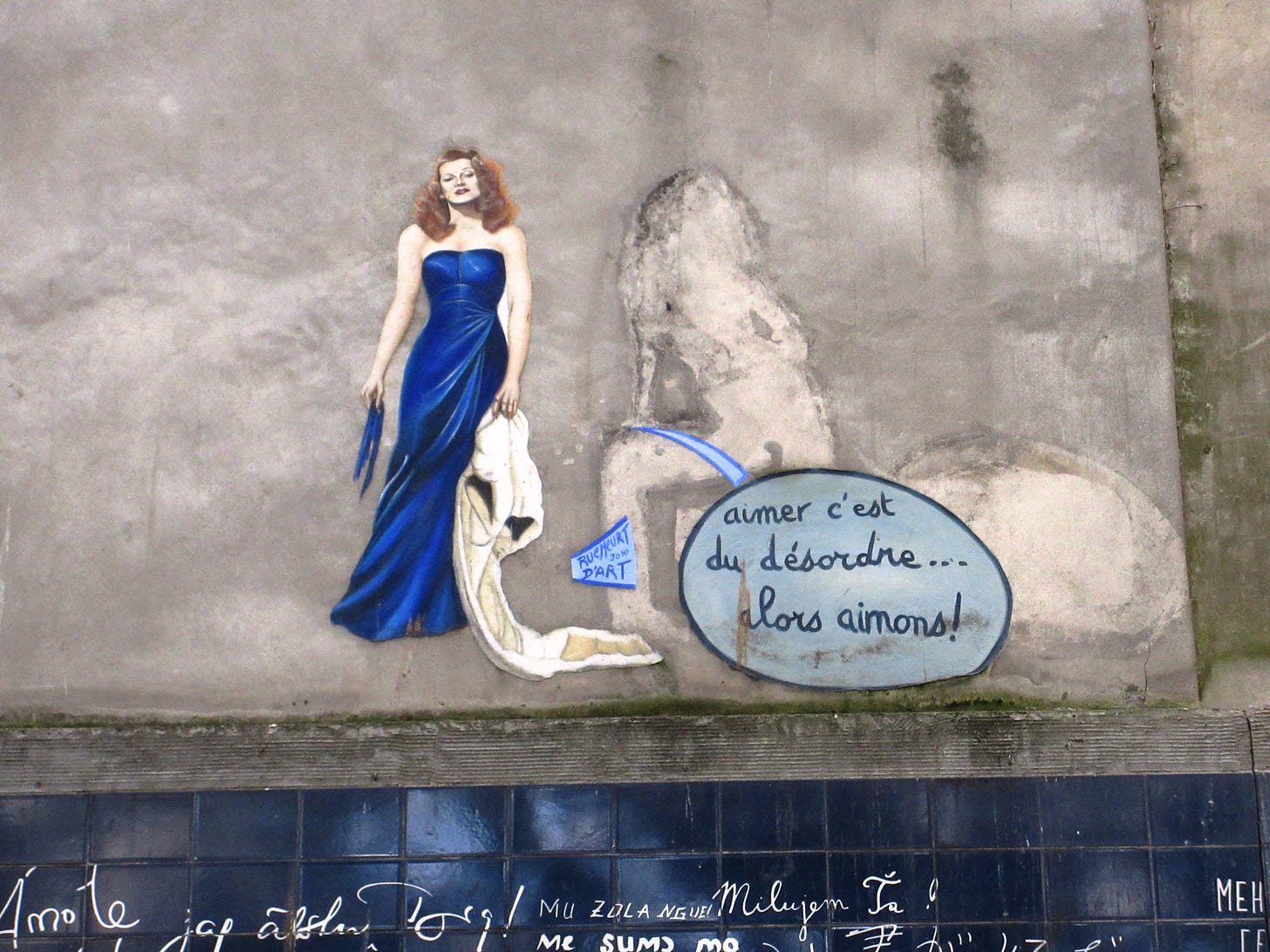 A picture of a woman painted on a wall in Paris.