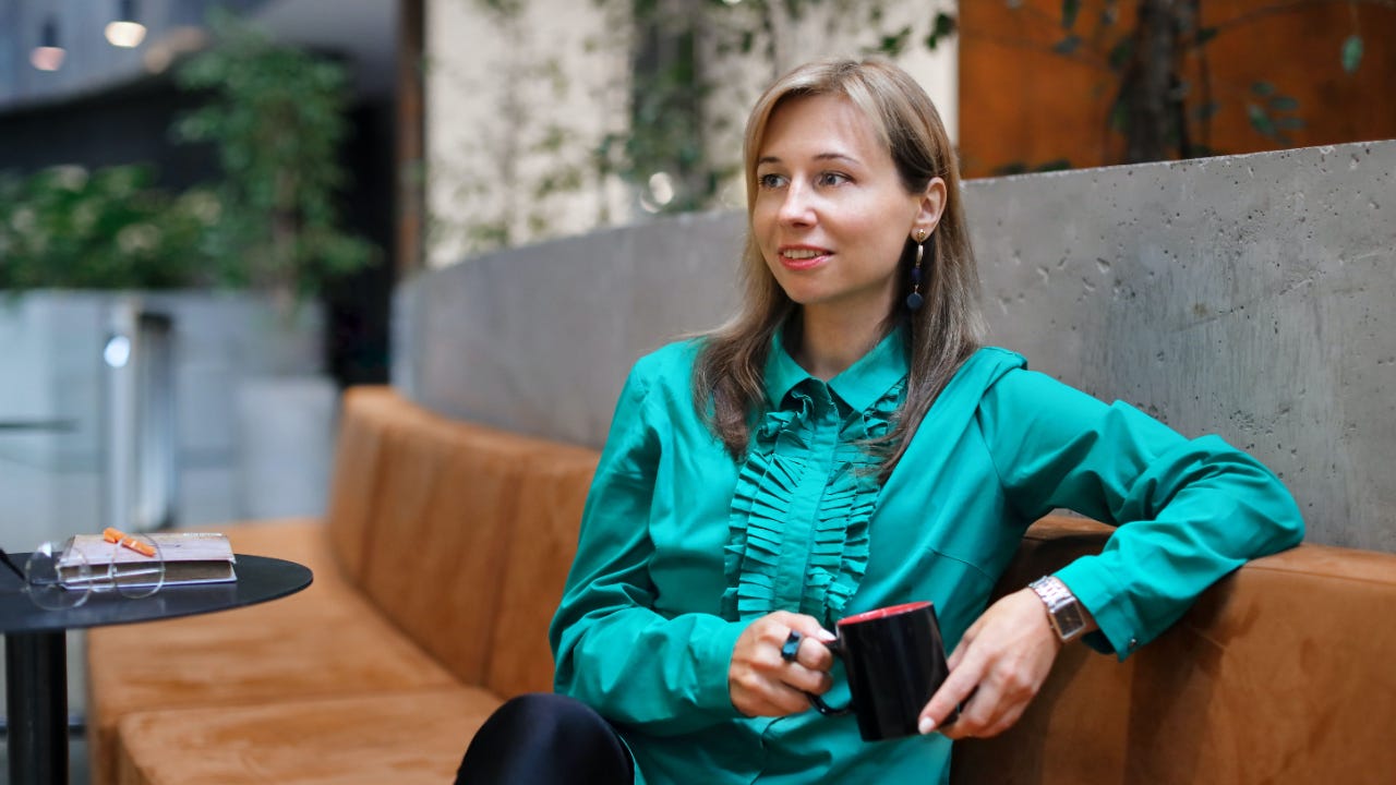 A woman drinking coffee thinking about her negative assumptions and communication