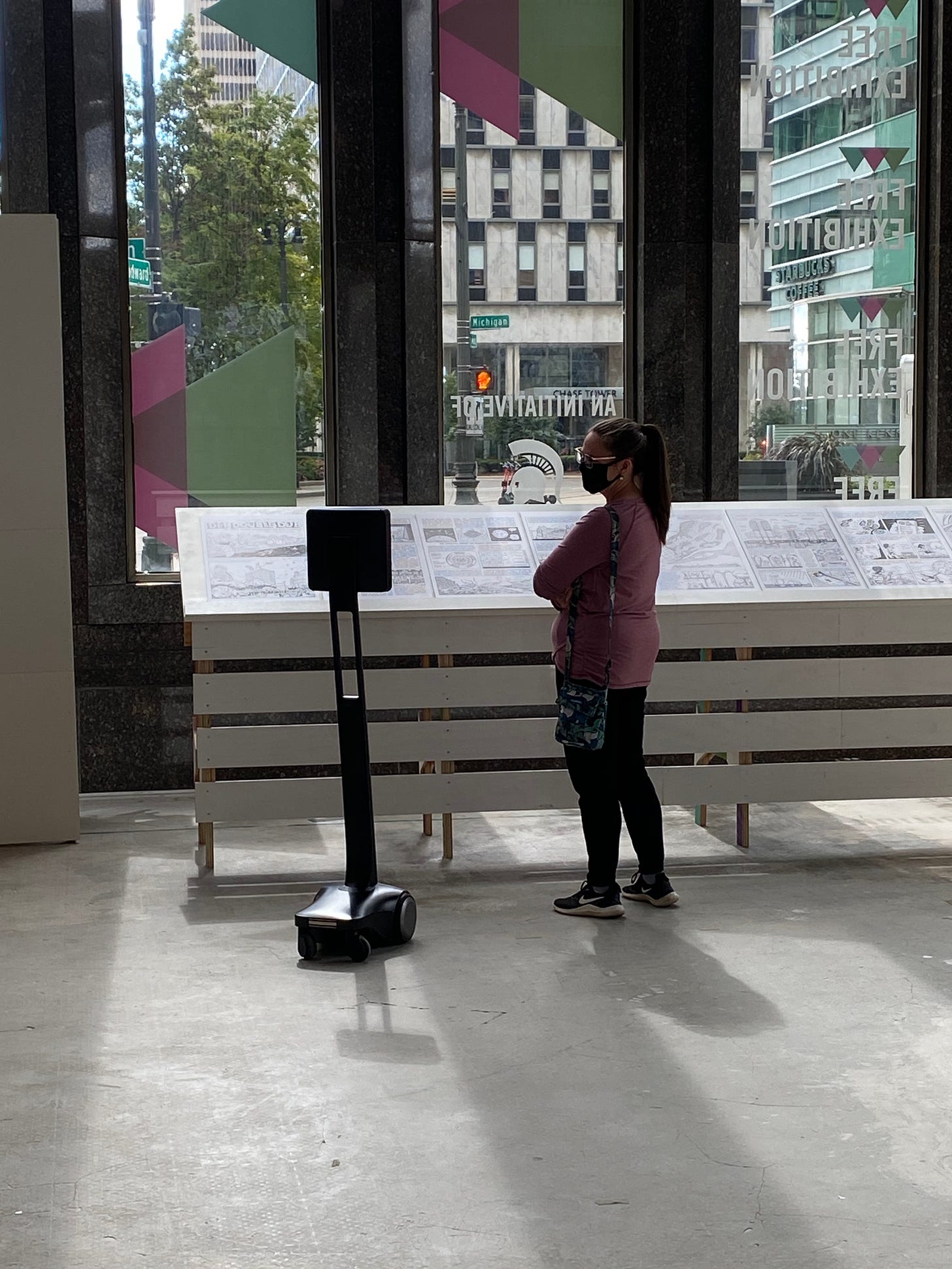 A visitor interacting with a telepresence robot in the Future Present exhibition.