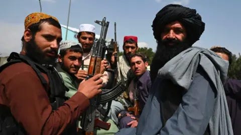 AFP Talban militants with guns on back of a pickup truck