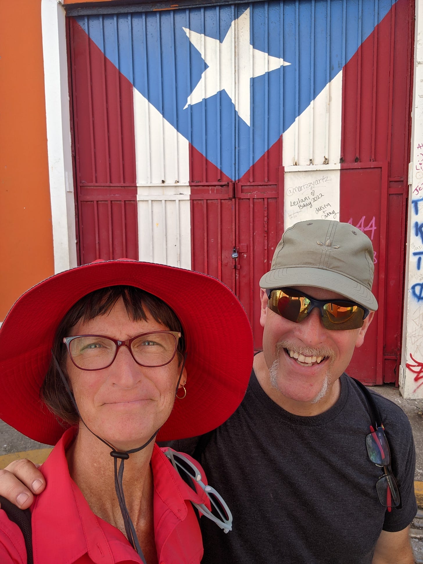 a picture of Andy and me in front of a door painted to look like a Puerto Rican flag