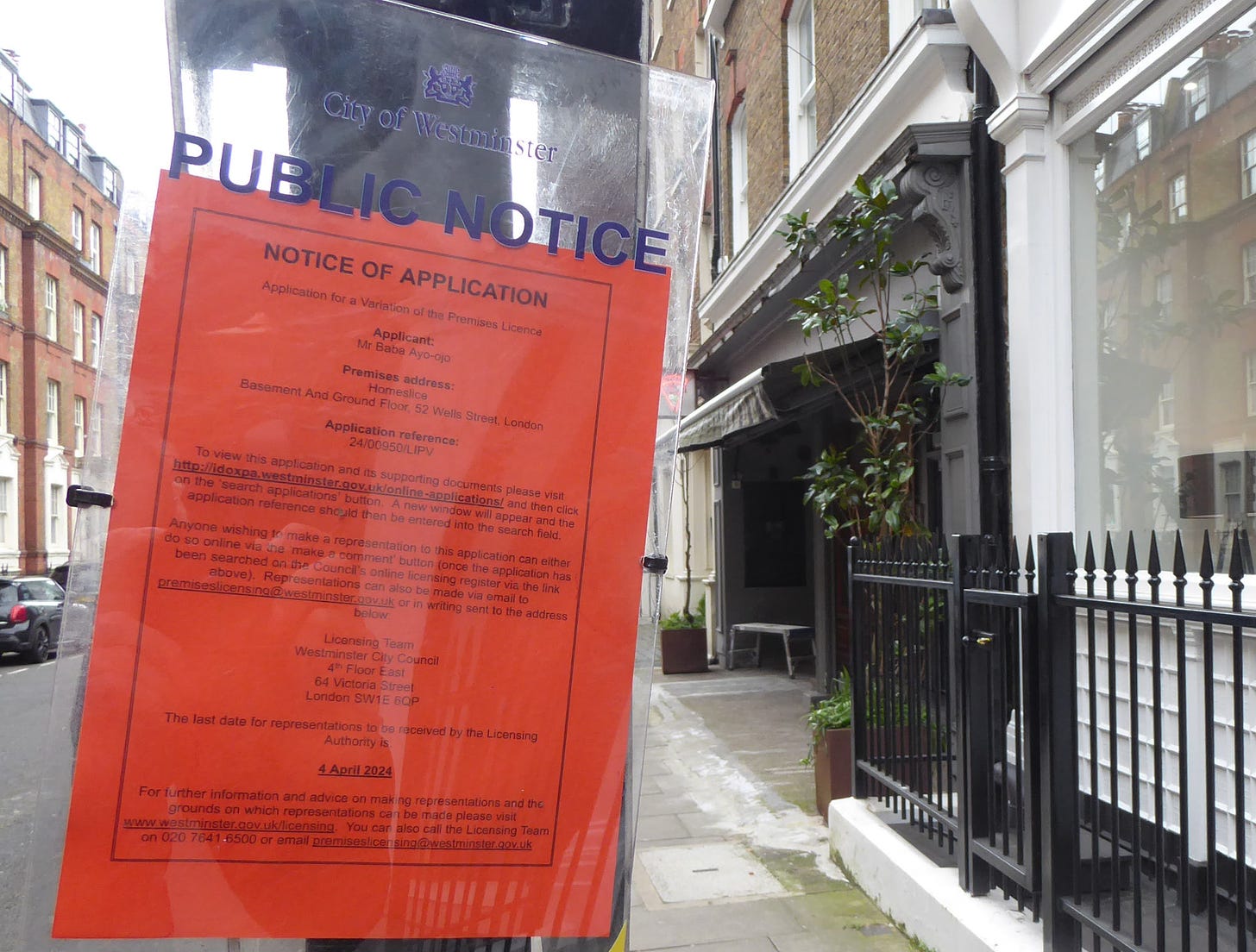 Notice of a licensing application to open until 2am posted on a lamppost.