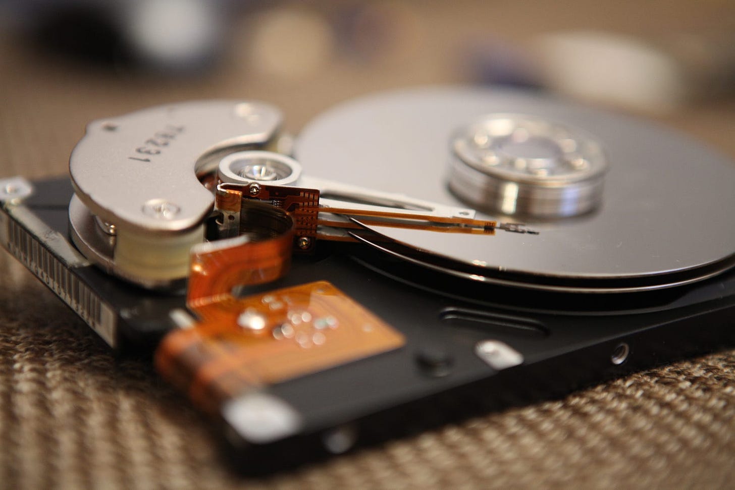 The internal workings of a hard drive with the foreground and background out of focus