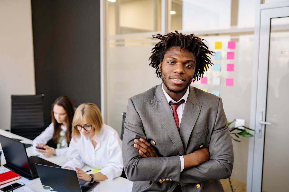 Free A Businessman and His Colleagues in the Office Stock Photo