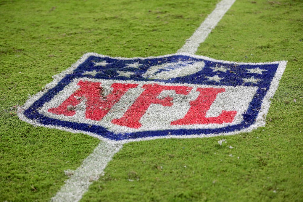 The NFL logo is painted on the turf during a NFL football game at EverBank Stadium, Saturday, August 26, 2023 in Jacksonville, Fla.