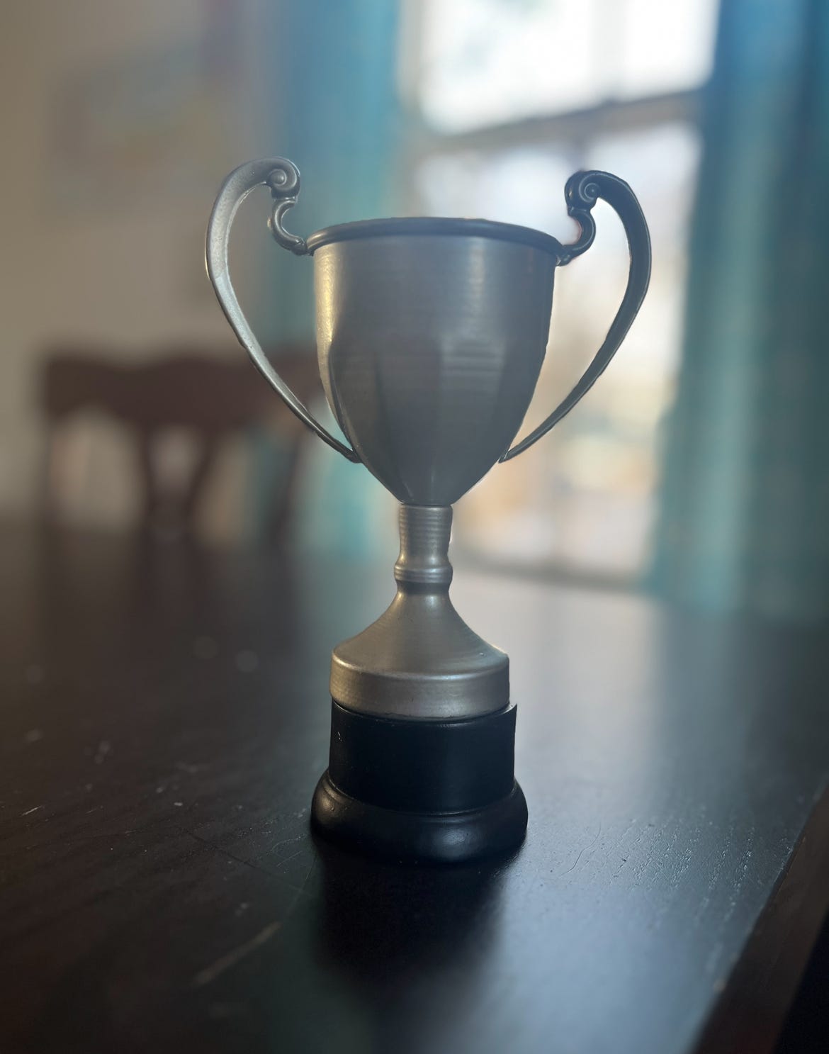 A small, two-handled cup-style trophy sitting on  my table