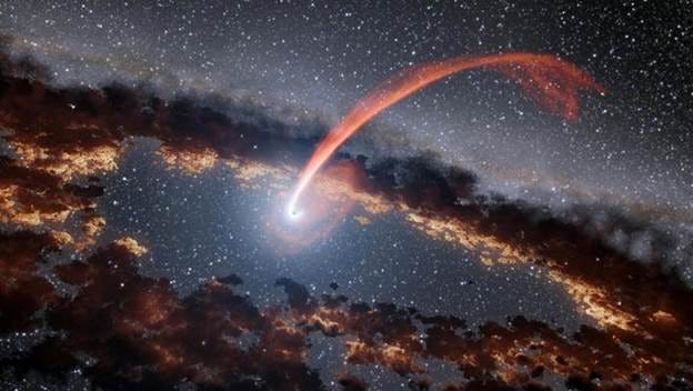 This illustration shows a glowing stream of material from a star as it is being devoured by a supermassive black hole. When a star passes within a certain distance of a black hole - close enough to be gravitationally disrupted - the stellar material gets stretched and compressed as it falls into the black hole.