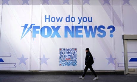 person walks past sign saying how do you fox news