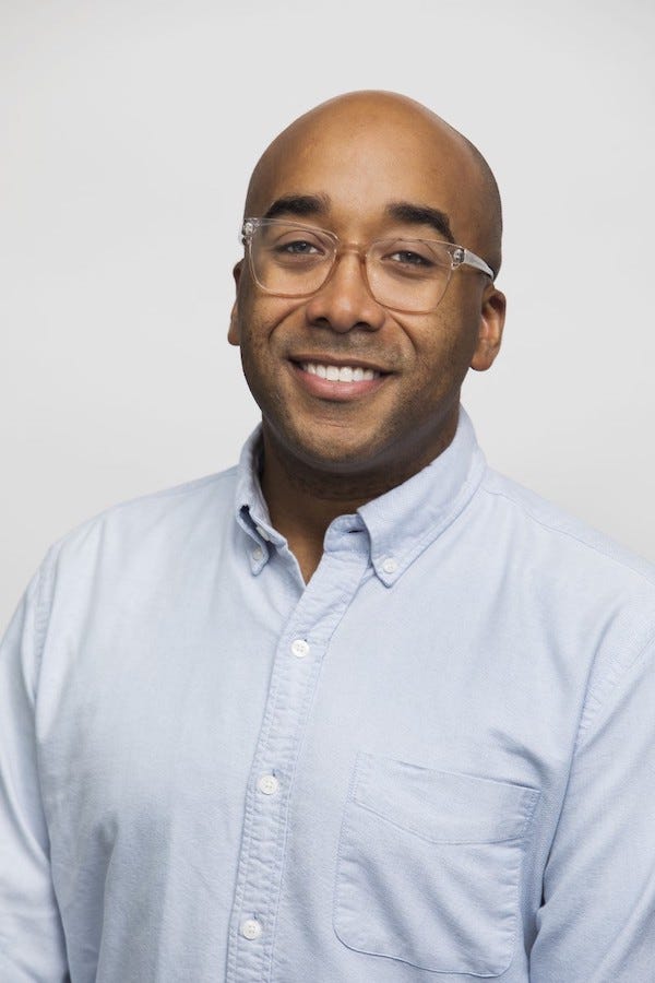 Head-and-torso photo of author Dr. Marcus Collins in a button-up shirt
