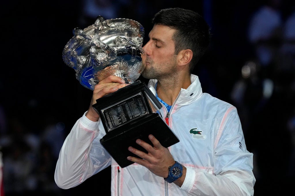 Novak Djokovic kisses the Norman Brookes Challenge Cup, after defeating Stefanos Tsitsipas of Greece at the Australian Open tennis championship in Melbourne, Australia on Jan. 29, 2023.