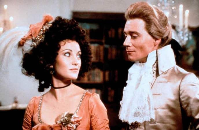 A still from the movie The Scarlet Pimpernel. Sir Percy Blakeney is standing on the right, next to a woman. 