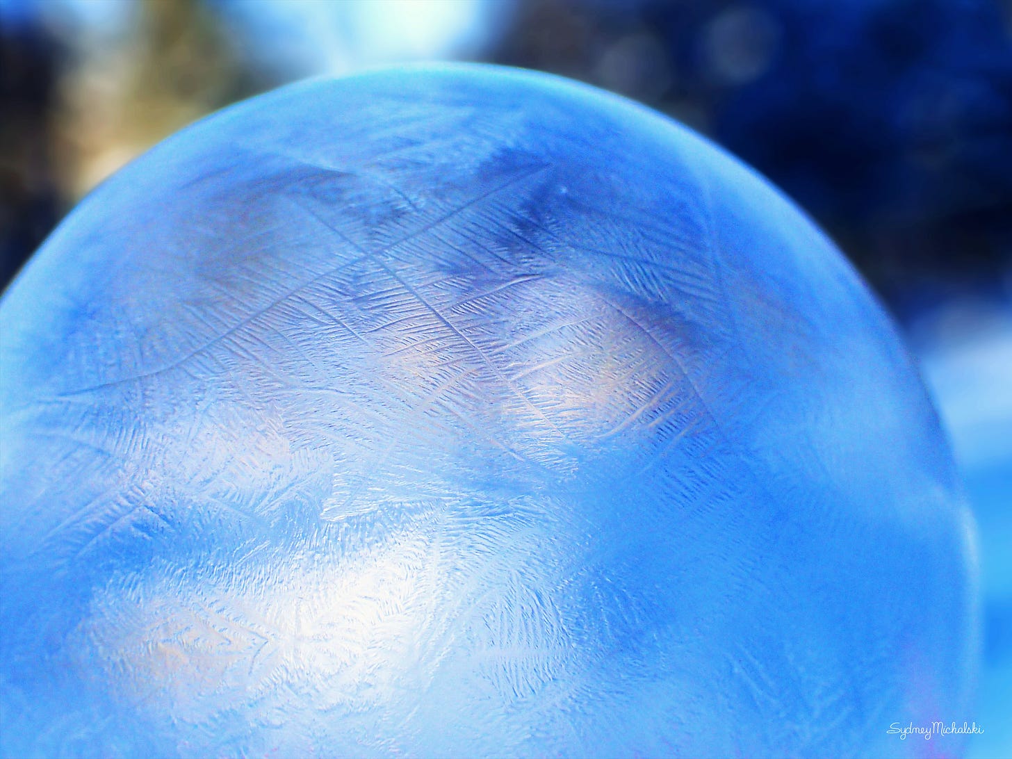 A close-up of the feathery crystal patterns in a frozen bubble.