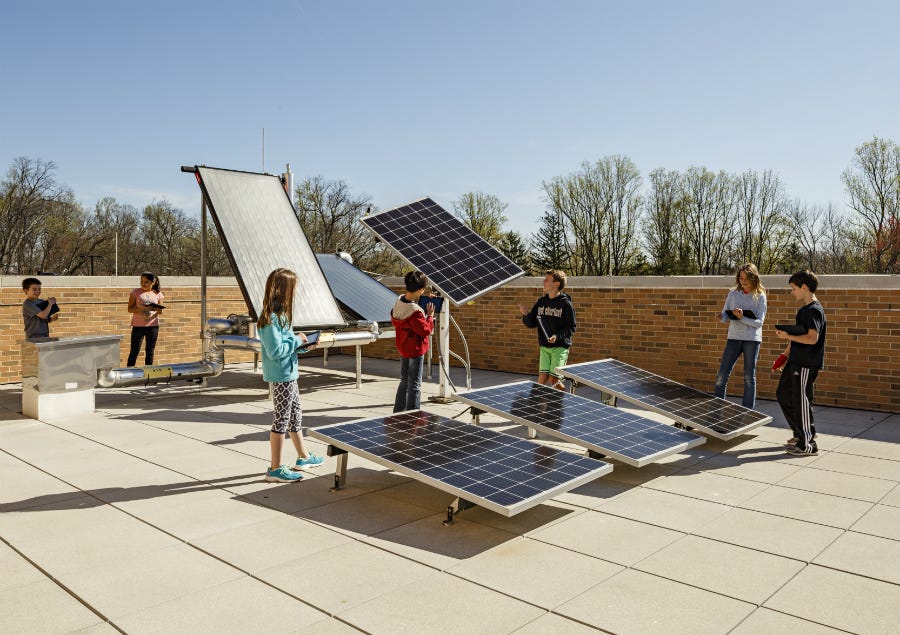 Students learn about different way solar energy can be harnessed in a rooftop lab at Discovery Elementary in Arlington, Virginia. The school has a 495-kilowatt solar array. Credit: Lincoln Barbour