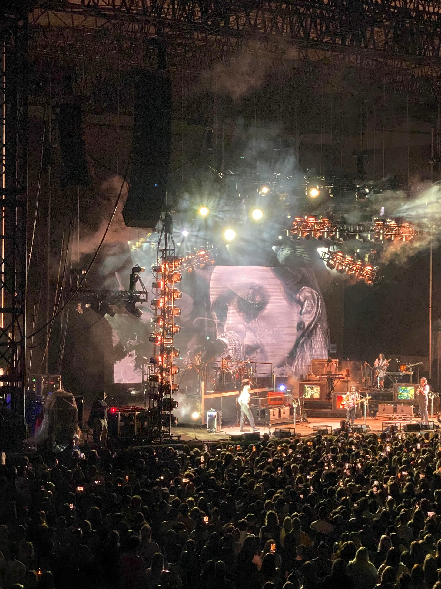 Sarah's photo of boygenius at Forest Hills Stadium, with a close up of Julien on screen