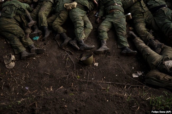 The bodies of 11 Russian soldiers lie on the ground in the village of Vilkhivka, near Kharkiv, Ukraine, on May 9.
