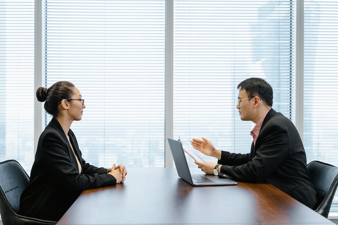 Free Man Interviewing a Woman Stock Photo