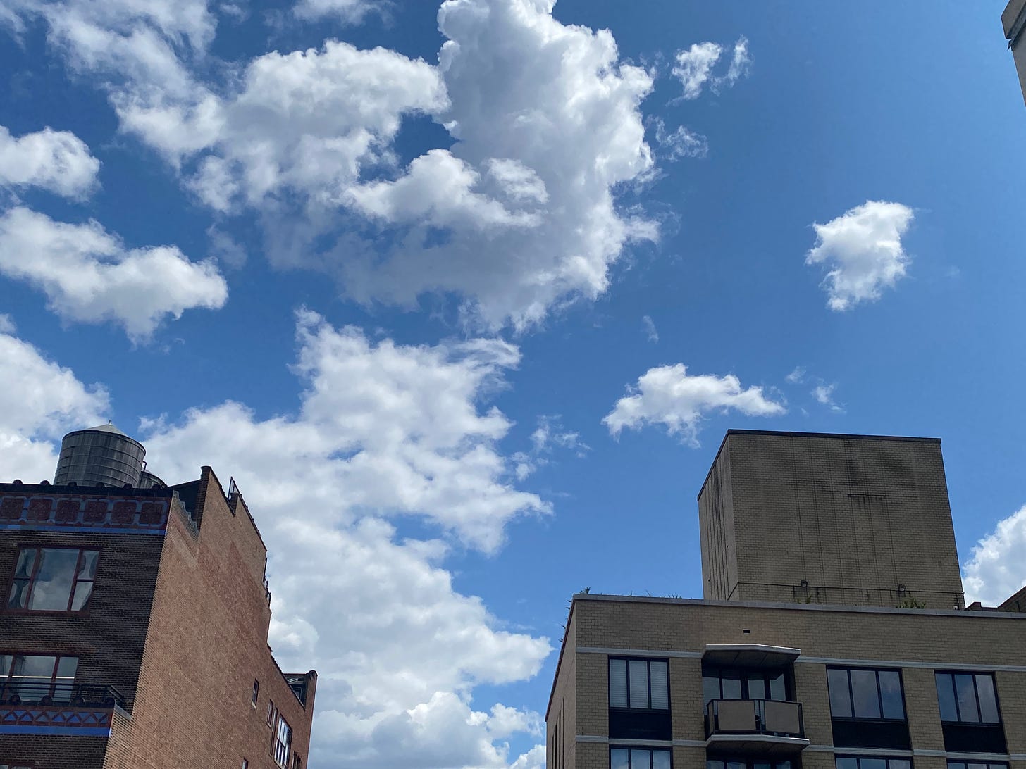 large skyscrapers against a blue sky with clouds