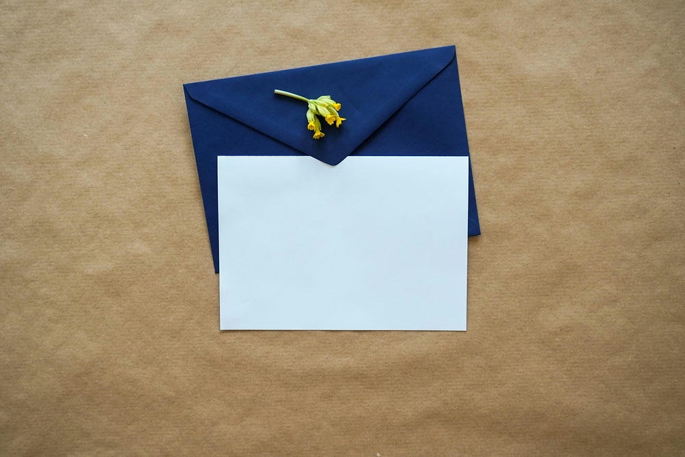 A Blank Invitation on a dark blue envelope.