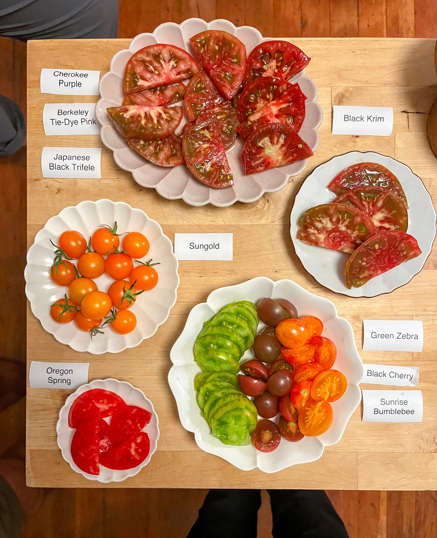 Kitchen island with nine types of tomatoes cut and labeled