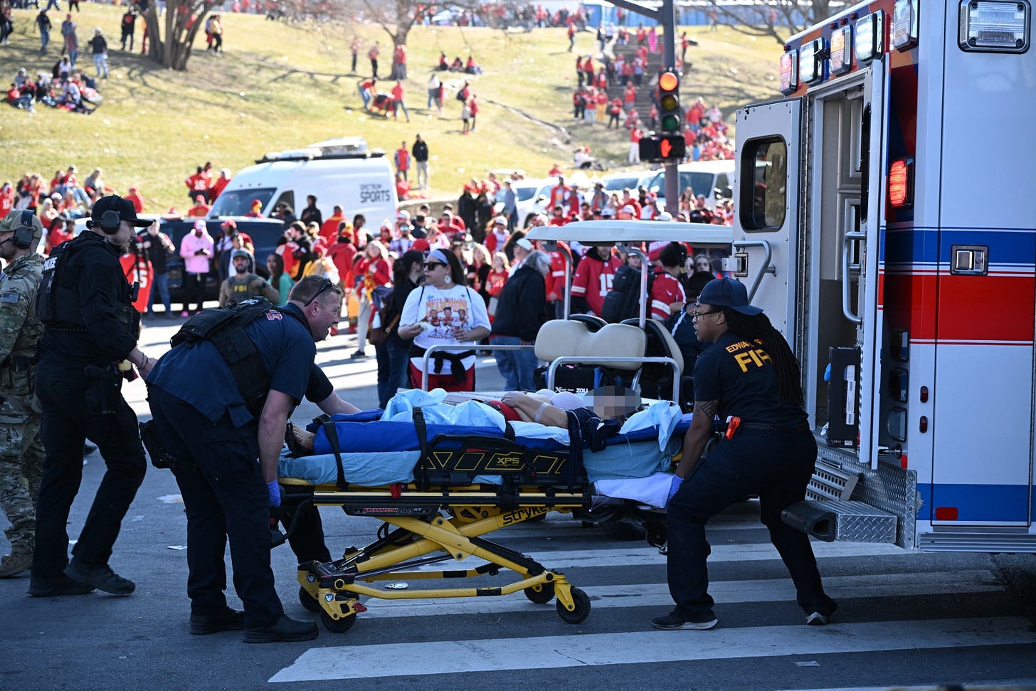 PHOTO: An injured person is loaded on an ambulance near the Kansas City Chiefs' Super Bowl LVIII victory parade, on Feb. 14, 2024, in Kansas City, Missouri. Shots were reportedly fired during the parade, according to police.