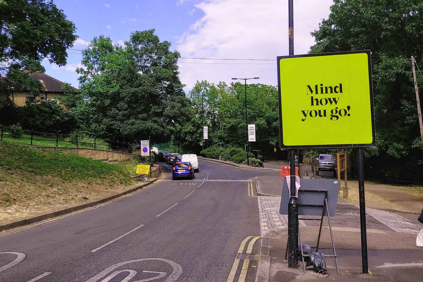 A roadsign reads, "Mind how you go!"