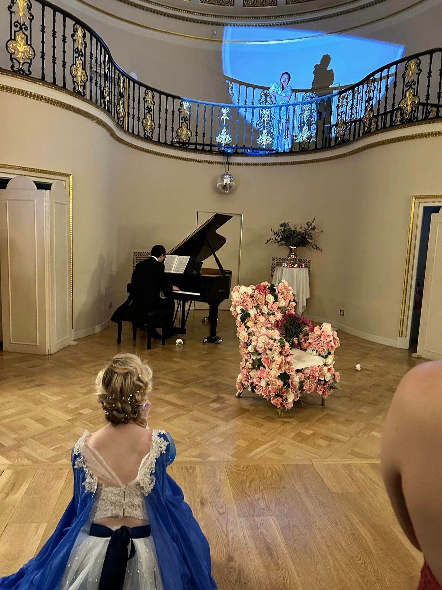 May be an image of 2 people, piano and candle holder