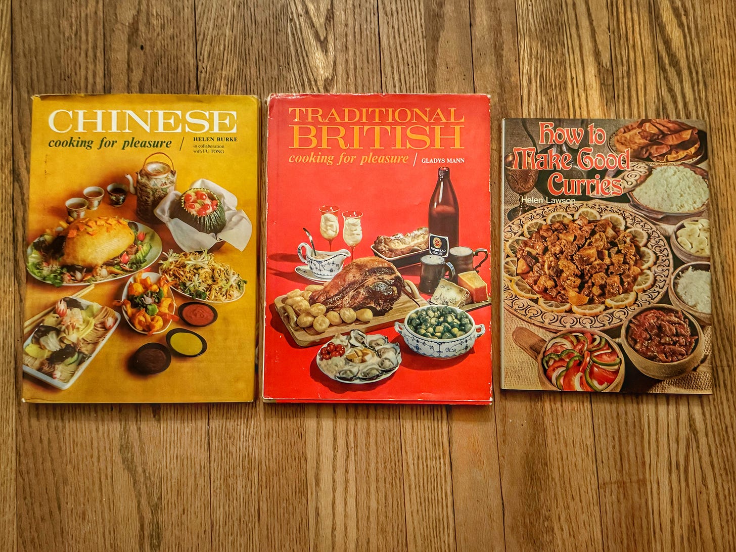 Copies of Chinese Cooking for Pleasure, Traditional British Cooking for Pleasure, and How to Make Good Curries, each showing a variety of dishes from their respective subjects