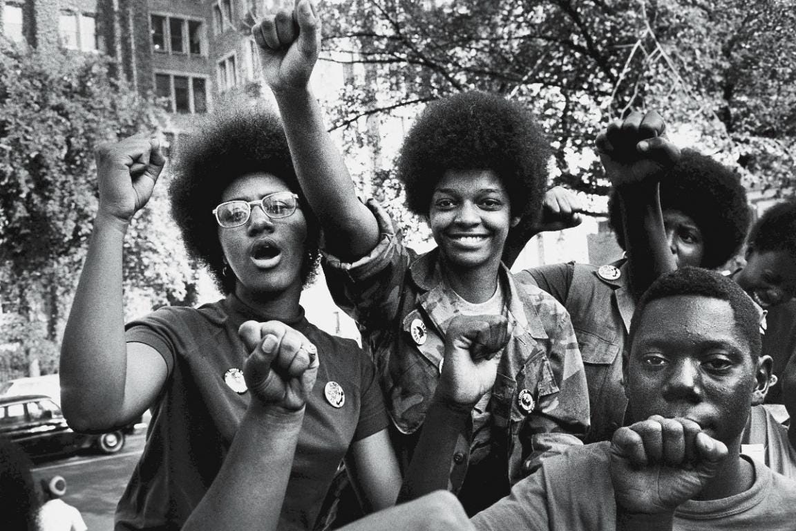 Fists in the air, attendees smile at the Revolutionary People's Party Constitutional Convention, Philadelphia, September 1970.
