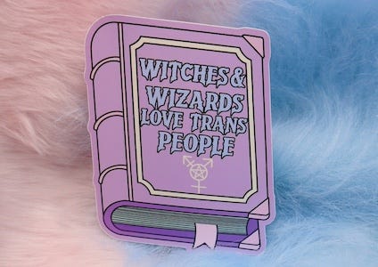 a sticker of a book with a trans symbol with a pentagram inside it and the text Witches and Wizards Love Trans People