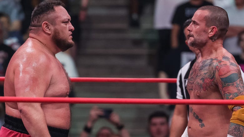 Samoa Joe and CM Punk staring at each other in AEW