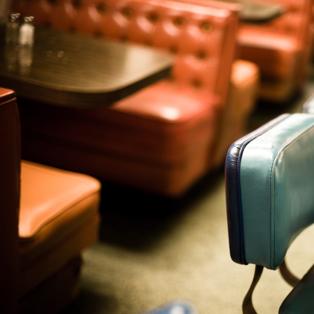 brown vinyl booths with woodgrain tables at a restaurant